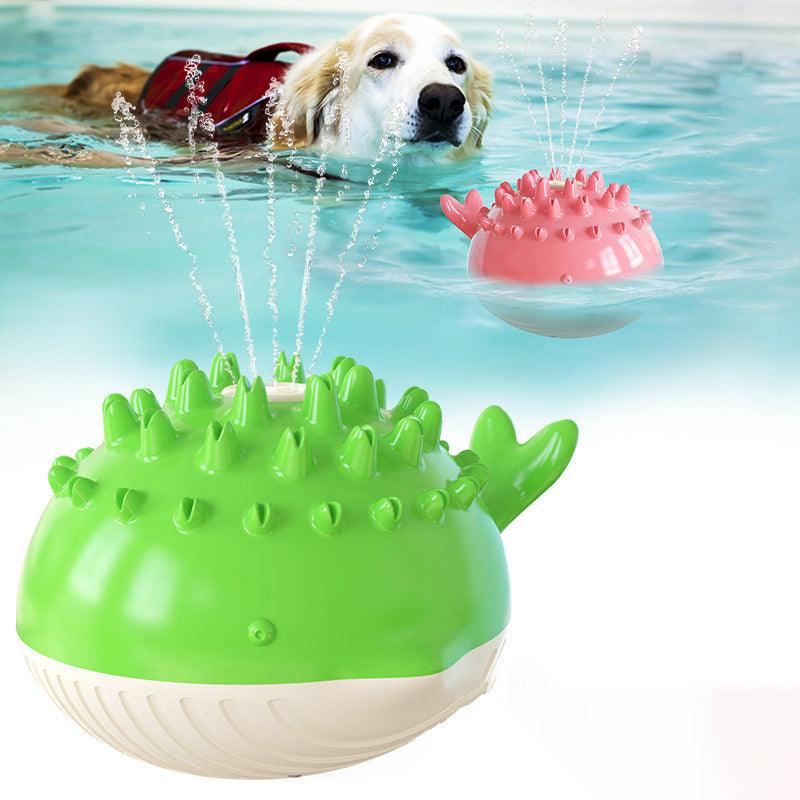 Green and pink spiky dog toy in water with a dog wearing a life jacket. The PetRiot